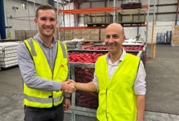 two men shaking hands in utility vest