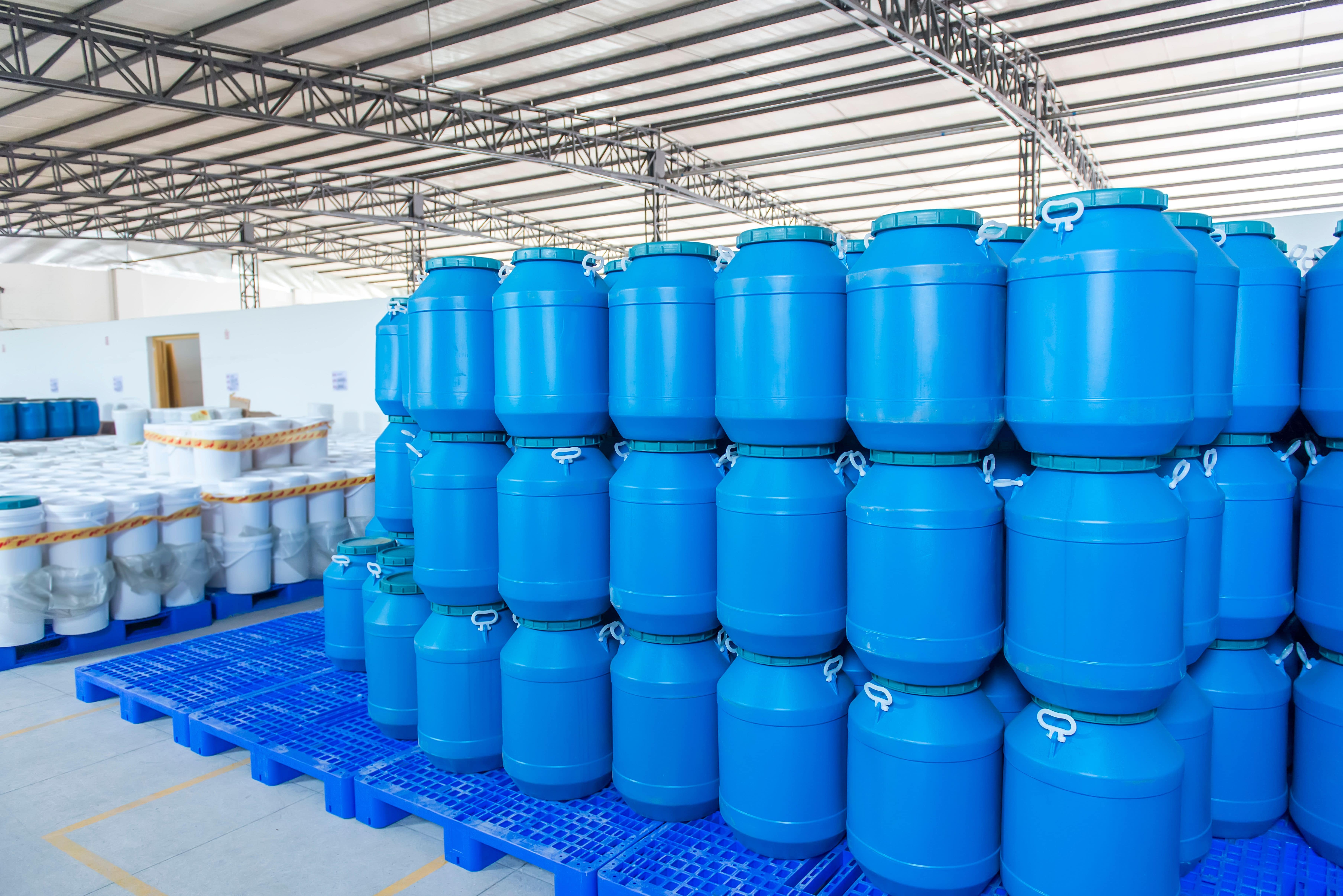 blue barrels stacked in a warehouse