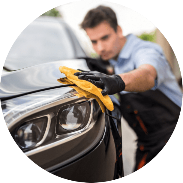 man cleaning car with yellow towel