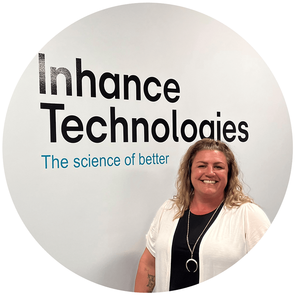 woman in front of inhance technologies logo