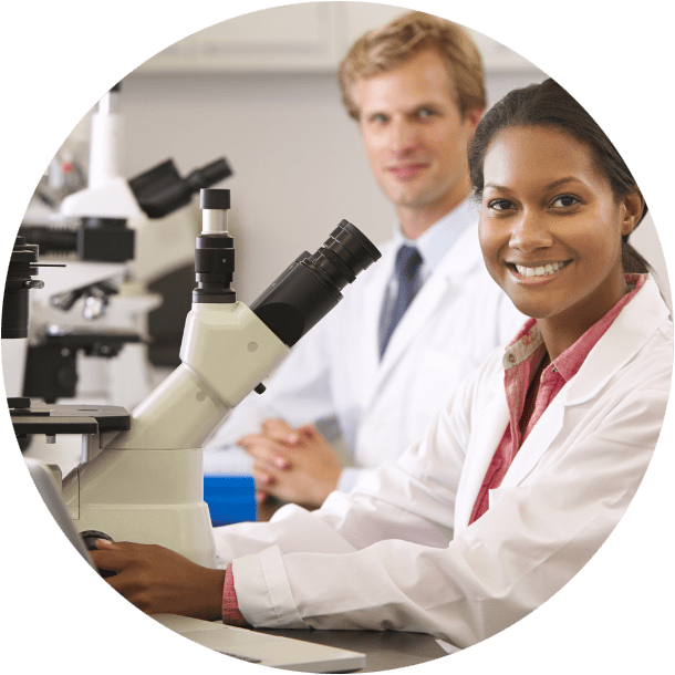 researchers holding microscope in a lab