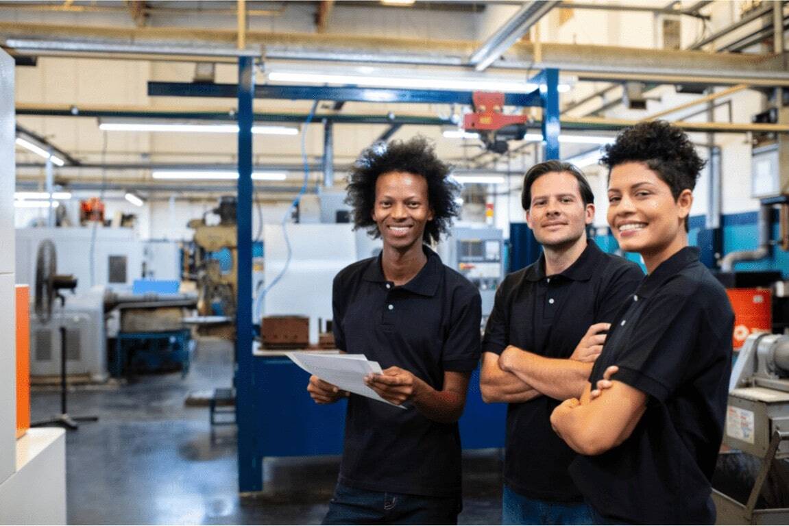 group in a warehouse wearing black polos